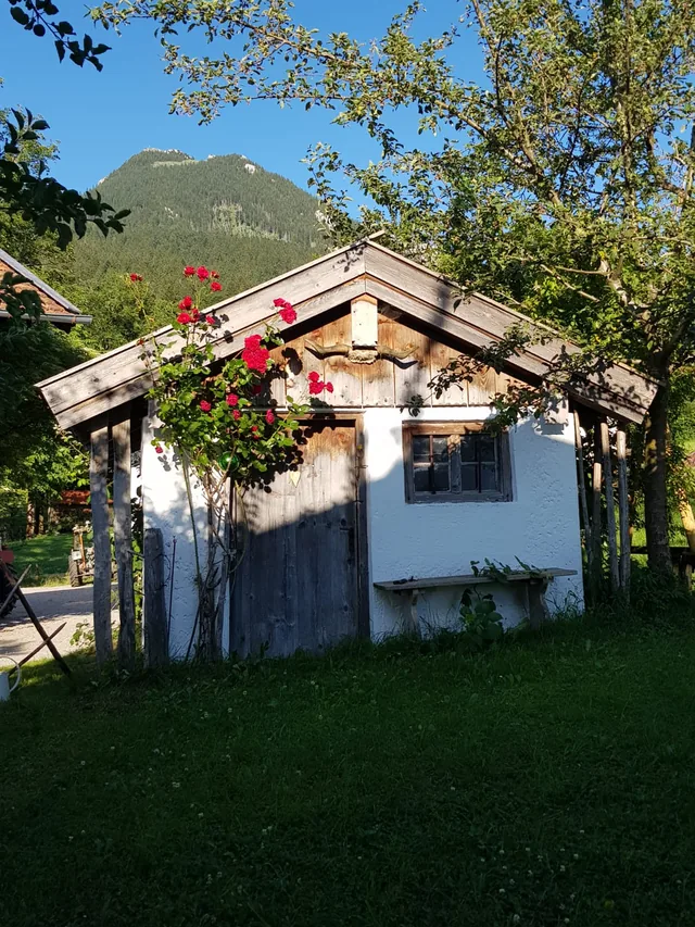 Das Häuschen im Sommer, mit Blumen am Balkon